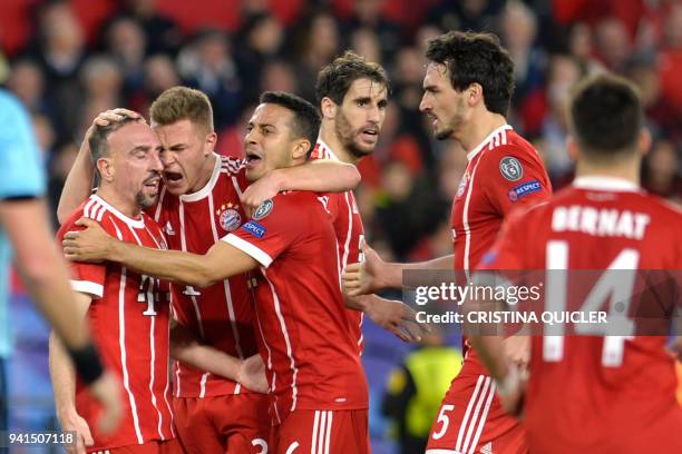 Bayern players celebrate Sevilla's Spanish midfielder Jesus Navas' own goal during the UEFA Champions League quarter-final first leg football match...