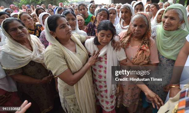 Ladies consoling Gian Kaur wife of Balwant Rai who was killed by the Islamic State Terror Group in Mosul , during his cremation in village Dhadhe on...