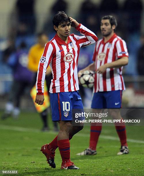 Atletico Madrid's Argentinian forward Sergio Aguero leaves the field injured as they play against FC Porto during their Champions League football...