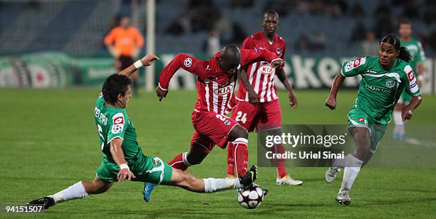 Jorge Teixeira of Maccabi Haifa and Henri Saivet of Bordeaux play the ball during their UEFA Champions League Group A matchday 6 game on December 8,...