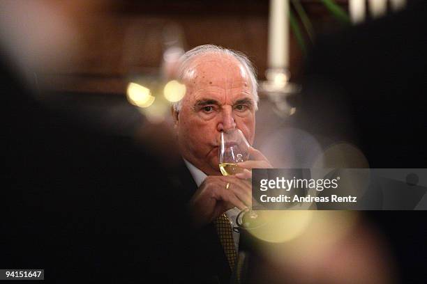 Former German Chancellor Helmut Kohl raise a glass of sparkling wine during a private dinner at Bellevue Pallace on December 8, 2009 in Berlin,...