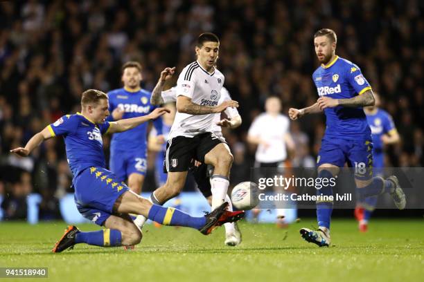 Aleksandar Mitrovic of Fulham is tackled by Matthew Pennington of Leeds United during the Sky Bet Championship match between Fulham and Leeds United...