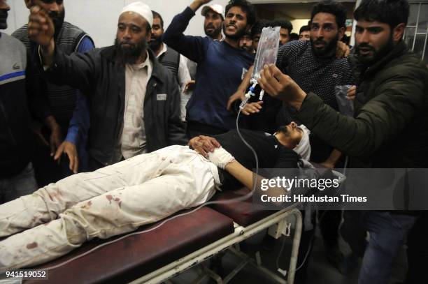 Kashmiri man injured during protests, brought for treatment inside a hospital on April 3, 2018 in Srinagar, India. Restrictions continued in parts of...