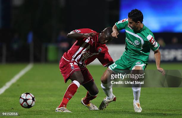 Baram Kayal of Maccabi Haifa and Abdou Traore of Bordeaux play the ball during their UEFA Champions League Group A matchday 6 game on December 8,...