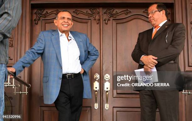 Former Honduran President Porfirio Lobo Sosa gestures next to his lawyer Julio Ramirez, after knowing that the Administrative Office of Seized Assets...