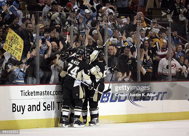 Mike Rupp of the Pittsburgh Penguins celebrates his goal with teammates against the Carolina Hurricanes in the second period at Mellon Arena on...