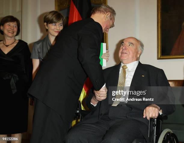 Former German Chancellor Helmut Kohl welcomes a guest as his wife Maike Richter-Kohl and First Lady Eva Luise Koehler look on during a private dinner...