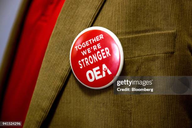 Demonstrator wears a button in support of the Oklahoma Education Association during a rally inside the Oklahoma State Capitol building in Oklahoma...