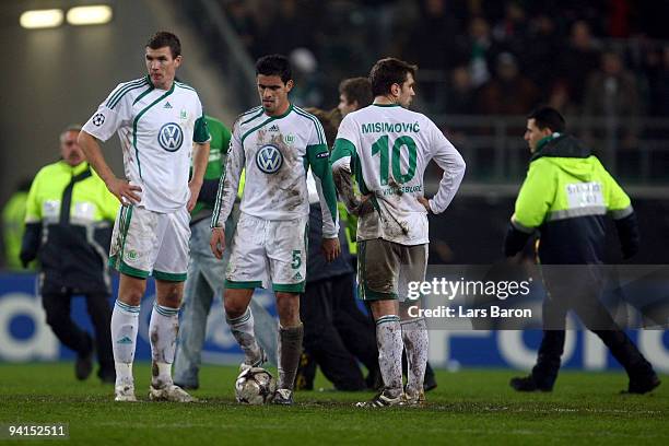 Edin Dzeko, Josue and Zvjezdan Misimovic of Wolfsburg are looking dejected after Michael Owen of Manchester scored his second goal during the UEFA...