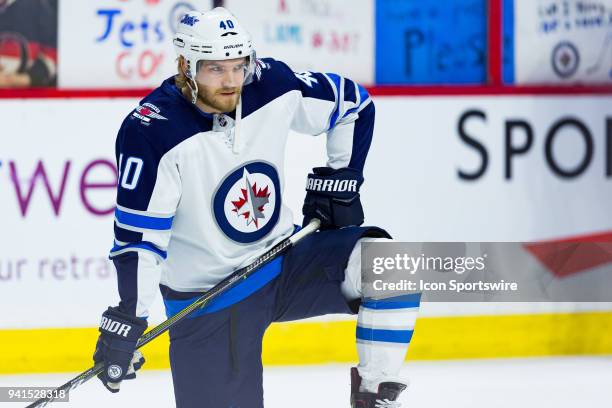 Winnipeg Jets Right Wing Joel Armia takes a knee during warm-up before National Hockey League action between the Winnipeg Jets and Ottawa Senators on...