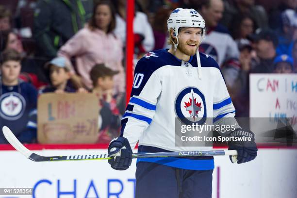 Winnipeg Jets Right Wing Joel Armia takes a moment during warm-up before National Hockey League action between the Winnipeg Jets and Ottawa Senators...