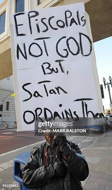 Protester who goes by the name Brother Williams demonstrates against the election of Reverend Canon Mary Glasspool, who is openly gay, to the...