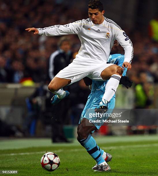 Cristiano Ronaldo of Real Madrid avoids the challenge of Taye Taiwo during the Marseille and Real Madrid UEFA Champions League Group C match at the...
