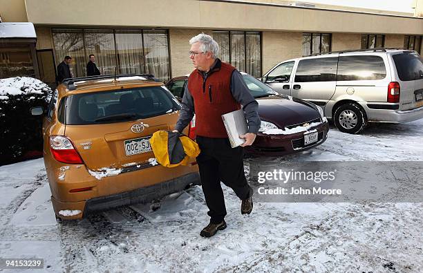 Mike Diener, who lost his job three months ago in sales, carries a folder of resumes after leaving a career fair December 8, 2009 in Denver,...