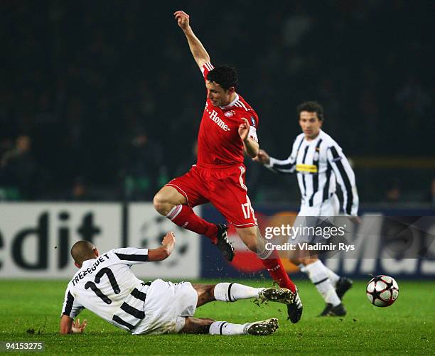 David Trezeguet of Juventus slides in to Mark Van Bommel of Bayern during the UEFA Champions League Group A match between Juventus Turin and FC...