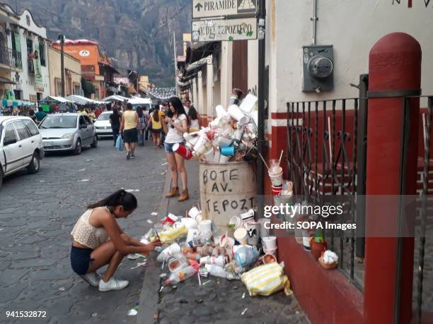 Young lady seen depositing trash in garbage containers exceeded their capacity, despite the large influx of tourism in Tepoztlan local authorities do...