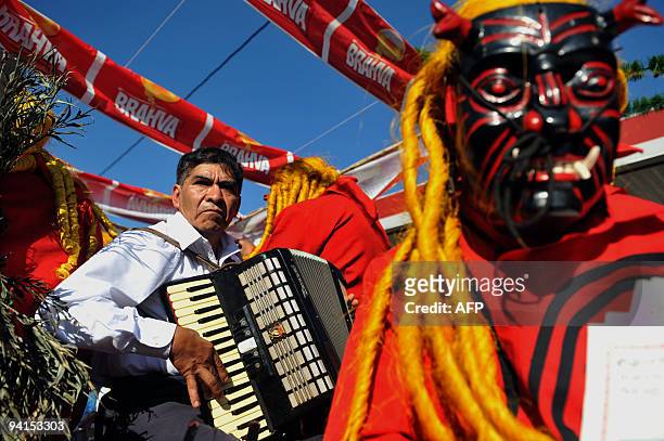 Man plays his accordion during the so called "Convite de Fieros" on the eve of the Virgin of the Immaculate Conception celebrations, on December 7,...