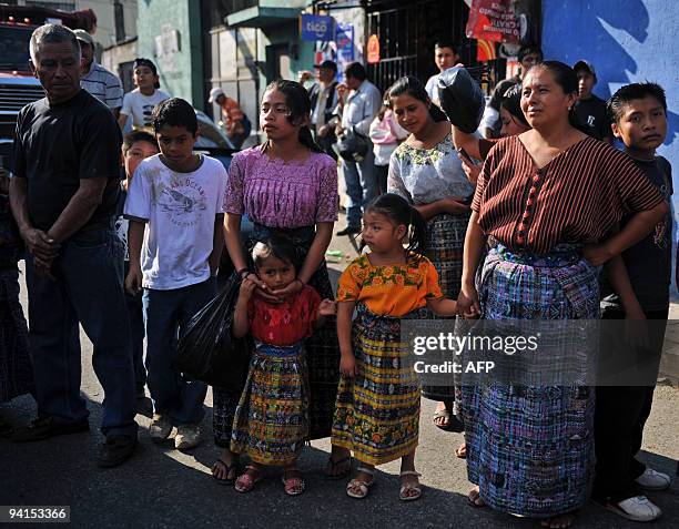 An indigenous family attends the so called "Convite de Fieros" event, on the eve of the Virgin of the Immaculate Conception celebrations, on December...