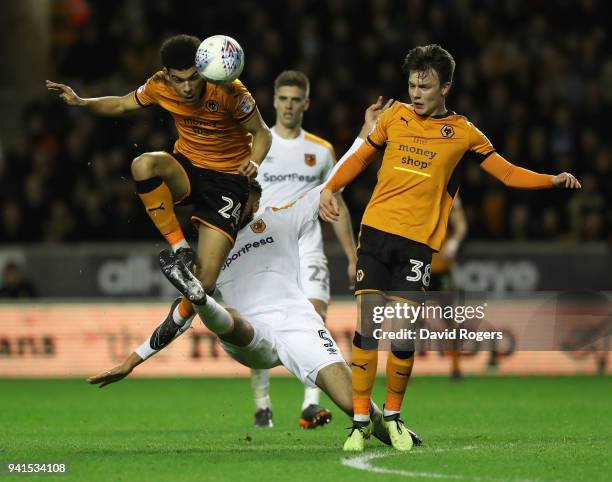 Morgan Gibbs-White of Wolves is challenged by Michael Hector as team mate Oskar Buur Rasmussen looks on during the Sky Bet Championship match between...