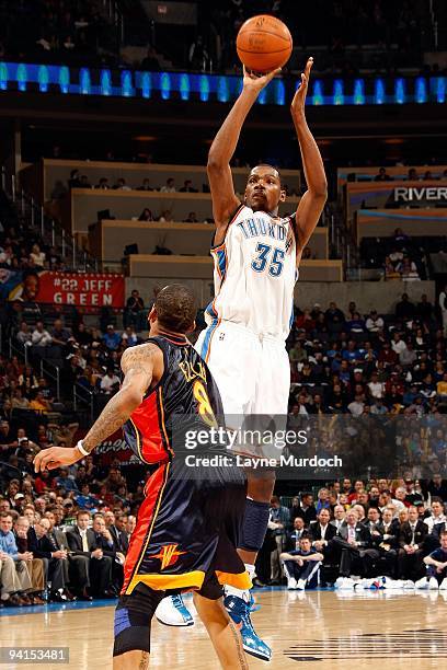 Kevin Durant of the Oklahoma City Thunder shoots against Monta Ellis of the Golden State Warriors during the game on December 7, 2009 at the Ford...