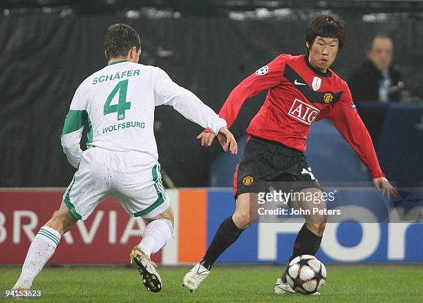 Ji-Sung Park of Manchester United clashes with Marcel Schafer of VfL Wolfsburg during the UEFA Champions League match between VfL Wolfsburg and...