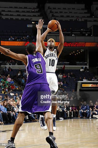 Jamaal Tinsley of the Memphis Grizzlies shoots a jump shot against Kenny Thomas of the Sacramento Kings during the game at the FedExForum on November...
