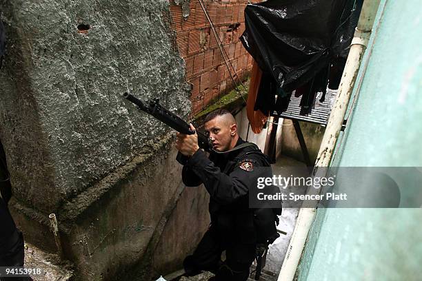 Member of Special Police Operations Battalion participates in a patrol searching homes for guns and drugs in the slum, or favela, Cantagalo in...