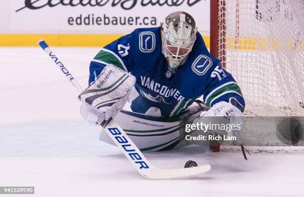 Goalie Jacob Markstrom of the Vancouver Canucks dives to cover up the puck in NHL action against the Edmonton Oilers on March 2018 at Rogers Arena in...