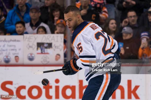 Darnell Nurse of the Edmonton Oilers plays with the puck prior to NHL action against the Vancouver Canucks on March 2018 at Rogers Arena in...