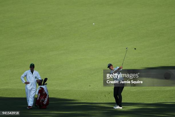 Brendan Steele of the United States plays a shot as caddie Christian Donald looks on during a practice round prior to the start of the 2018 Masters...