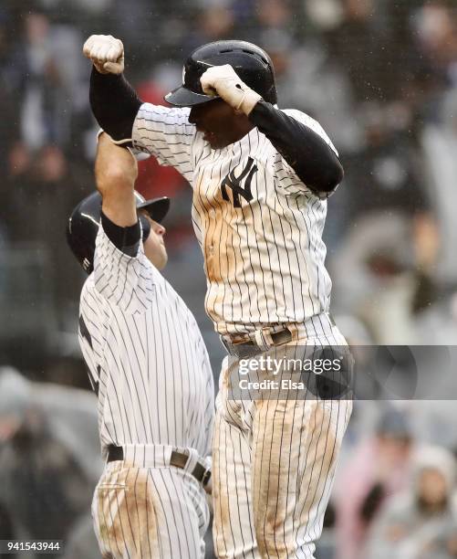 Brett Gardner congratulates teammate Didi Gregorius of the New York Yankees after Gregorius hit a three run home run in the third inning against the...