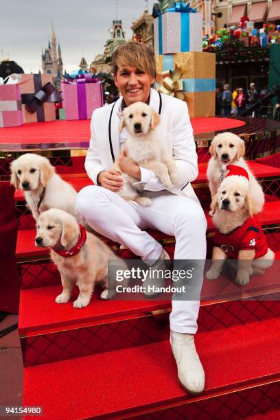 In this handout photo provided by Disney, Singer Steve Rushton poses at the Magic Kingdom on December 6, 2009 in Lake Buena Vista, Florida, with the...