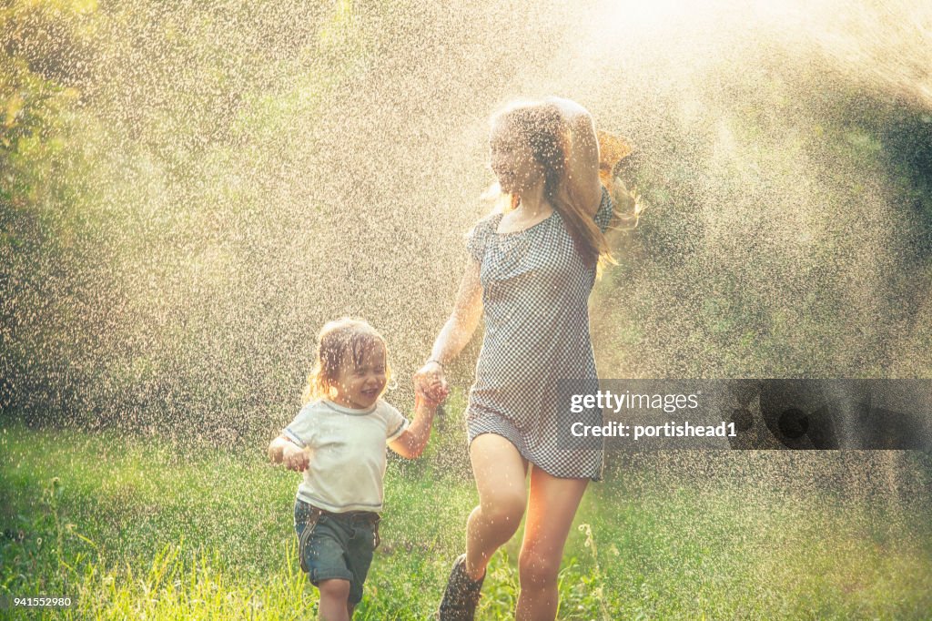 Mother and child running in the rain
