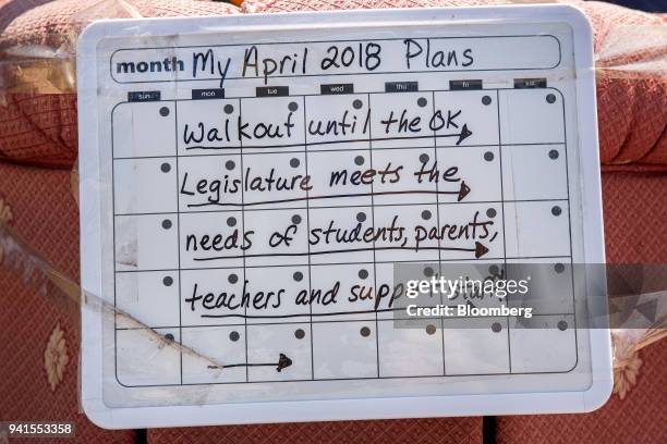 Sign is displayed during a teachers' strike outside the Oklahoma State Capitol building in Oklahoma City, Oklahoma, U.S., on Tuesday, April 3, 2018....