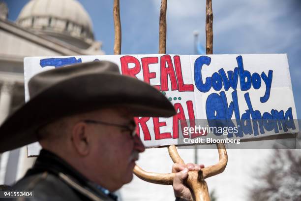 Demonstrator holds a sign during a teachers' strike outside the Oklahoma State Capitol building in Oklahoma City, Oklahoma, U.S., on Tuesday, April...