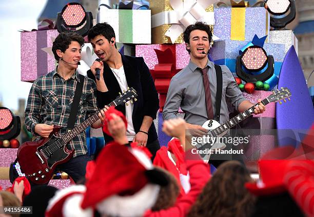 In this handout photo provided by Disney, The Jonas Brothers Nick Jonas, Joe Jonas and Kevin Jonas perform in front of Cinderella Castle at the Magic...