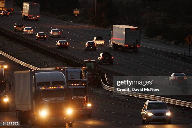 Diesel trucks and cars travel the 10 freeway on December 8, 2009 near Banning, California. Sustained global warming shows no sign of letting up...