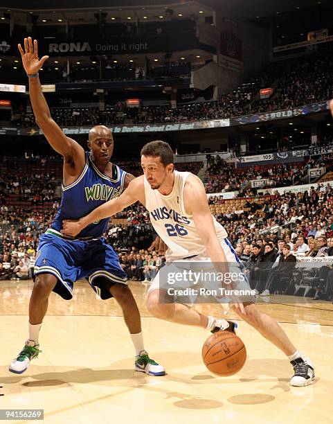 Hedo Turkoglu of the Toronto Raptors wearing a commemorative Toronto Huskies jersey, looks to drive past defender Damien Wilkins of the Minnesota...