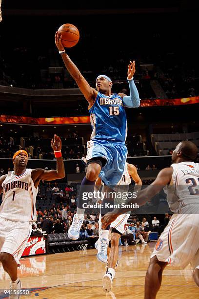 Carmelo Anthony of the Denver Nuggets goes up for the layup against Stephen Jackson of the Charlotte Bobcats on December 8, 2009 at the Time Warner...