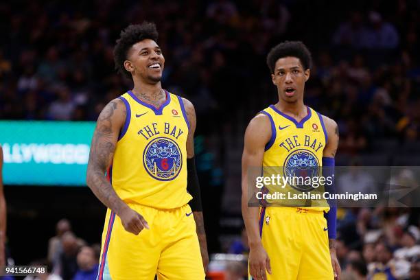 Nick Young of the Golden State Warriors talks with teammate Patrick McCaw during their game against the Sacramento Kings at Golden 1 Center on March...