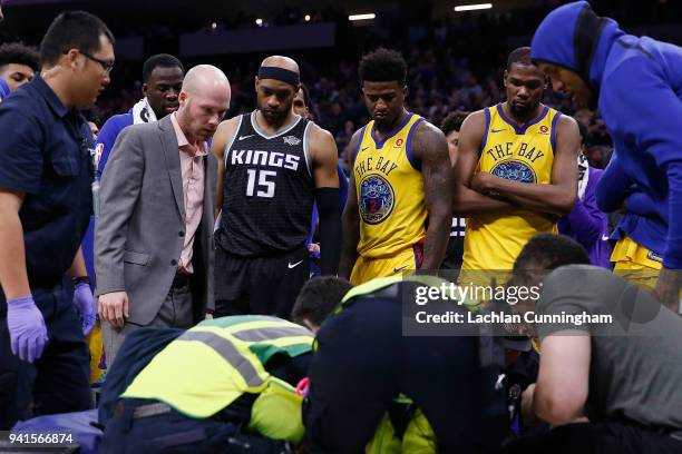 Vince Carter of the Sacramento Kings looks on as Patrick McCaw of the Golden State Warriors is loaded onto a stretcher following a play where he was...