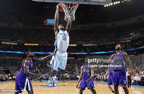 Emeka Okafor of the New Orleans Hornets dunks on Tyreke Evans, Kenny Thomas and Jason Thompson of the Sacramento Kings on December 8, 2009 at the New...