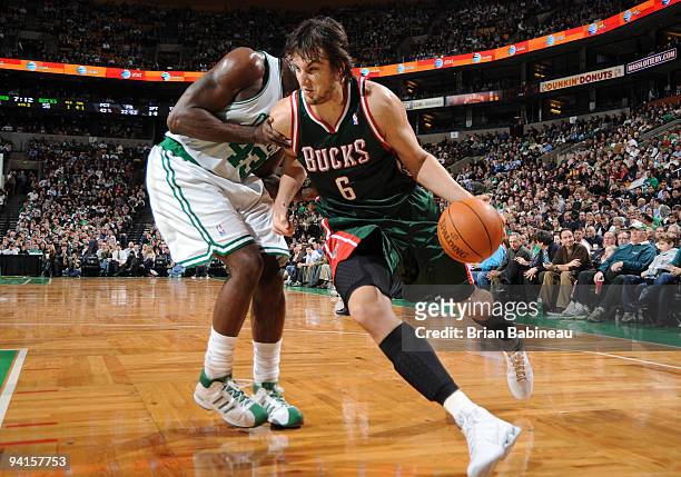 Andrew Bogut of the Milwaukee Bucks drives to the basket against Kendrick Perkins of the Boston Celtics on December 8, 2009 at the TD Garden in...