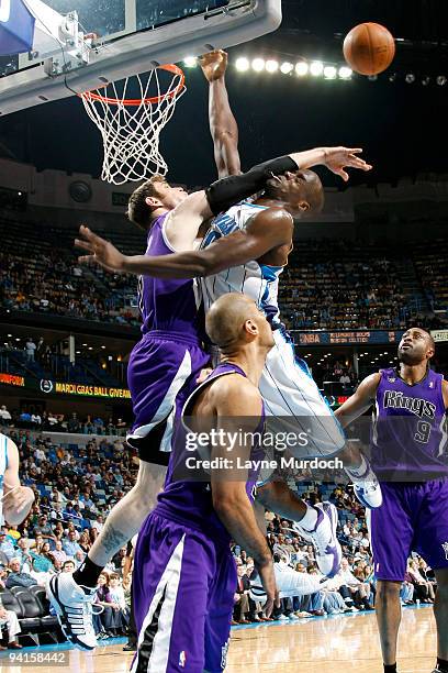 Emeka Okafor of the New Orleans Hornets attempts to shoot over Andres Nocioni of the Sacramento Kings on December 8, 2009 at the New Orleans Arena in...