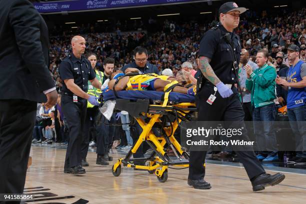 Patrick McCaw of the Golden State Warriors is taken off the court following an injury during the game against the Sacramento Kings on March 31, 2018...