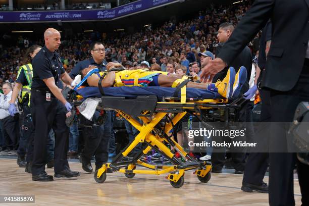 Patrick McCaw of the Golden State Warriors is taken off the court following an injury during the game against the Sacramento Kings on March 31, 2018...