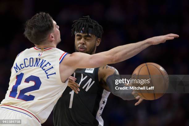 Angelo Russell of the Brooklyn Nets passes the ball against T.J. McConnell of the Philadelphia 76ers in the second quarter at the Wells Fargo Center...