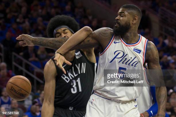 Jarrett Allen of the Brooklyn Nets gets tangled with Amir Johnson of the Philadelphia 76ers in the first quarter at the Wells Fargo Center on April...