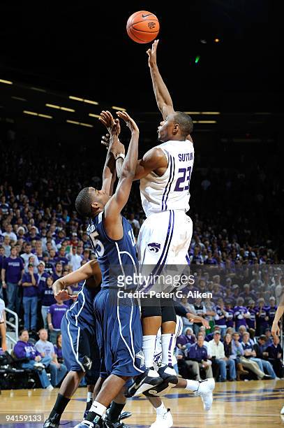 Forward Dominique Sutton of the Kansas State Wildcats scores over guard Jordan Crawford of the Xavier Musketeers in the second half on December 8,...