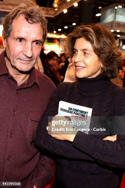 Journalist Jean-Jacques Bourdin and Reporter Anne Nivat poses during Paris Book Fair 2018 at Parc Des Expositions Porte de Versailles, France on .